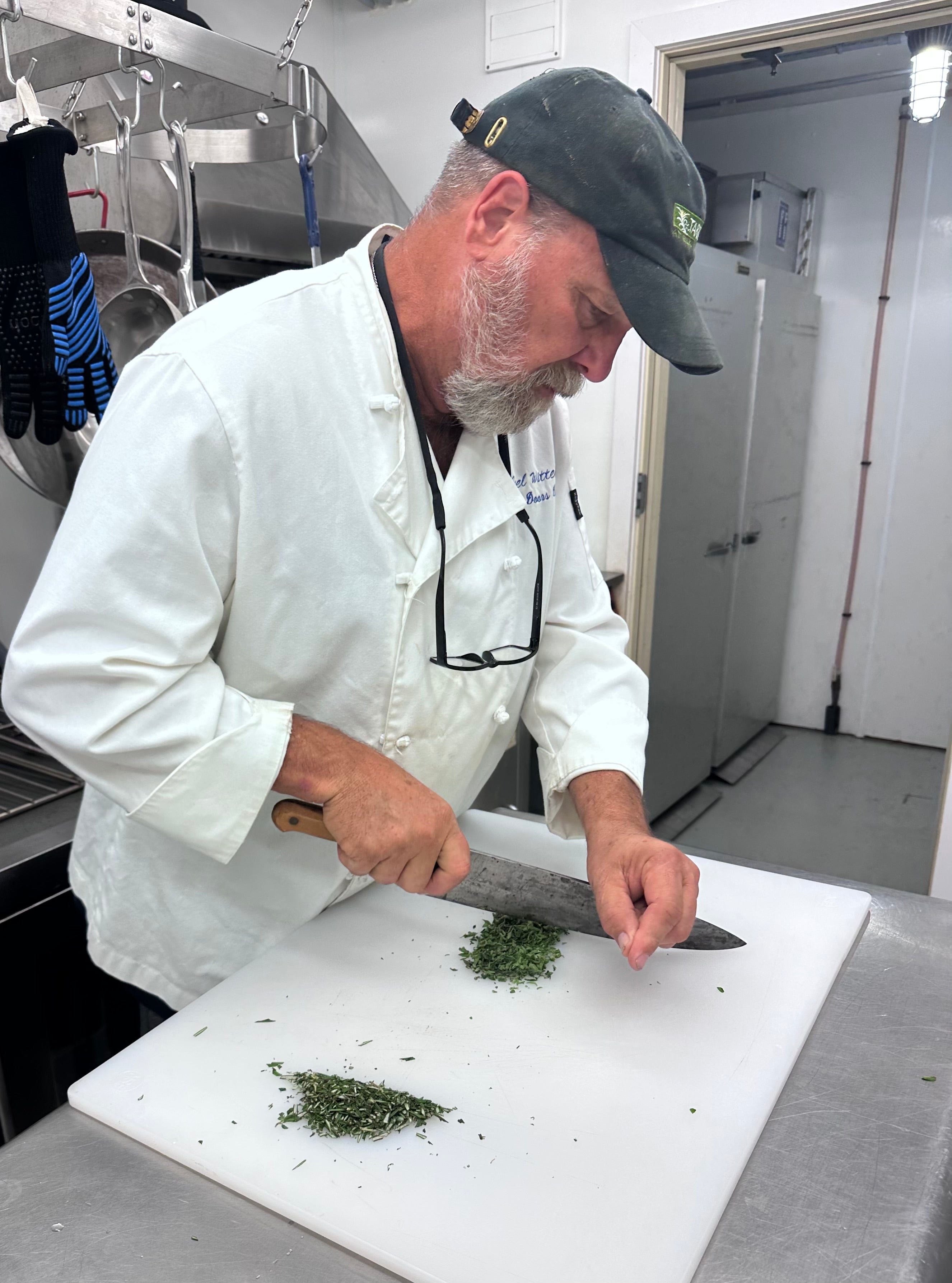 Chef Joel chopping the fresh herbs we use in Café de Paris Compount Butter.